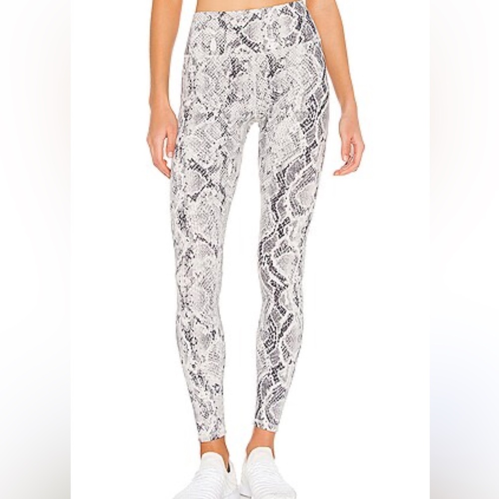 ALO Yoga Cream and Black Snakeskin Leggings